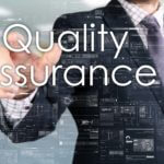 Business man clicking quality assurance